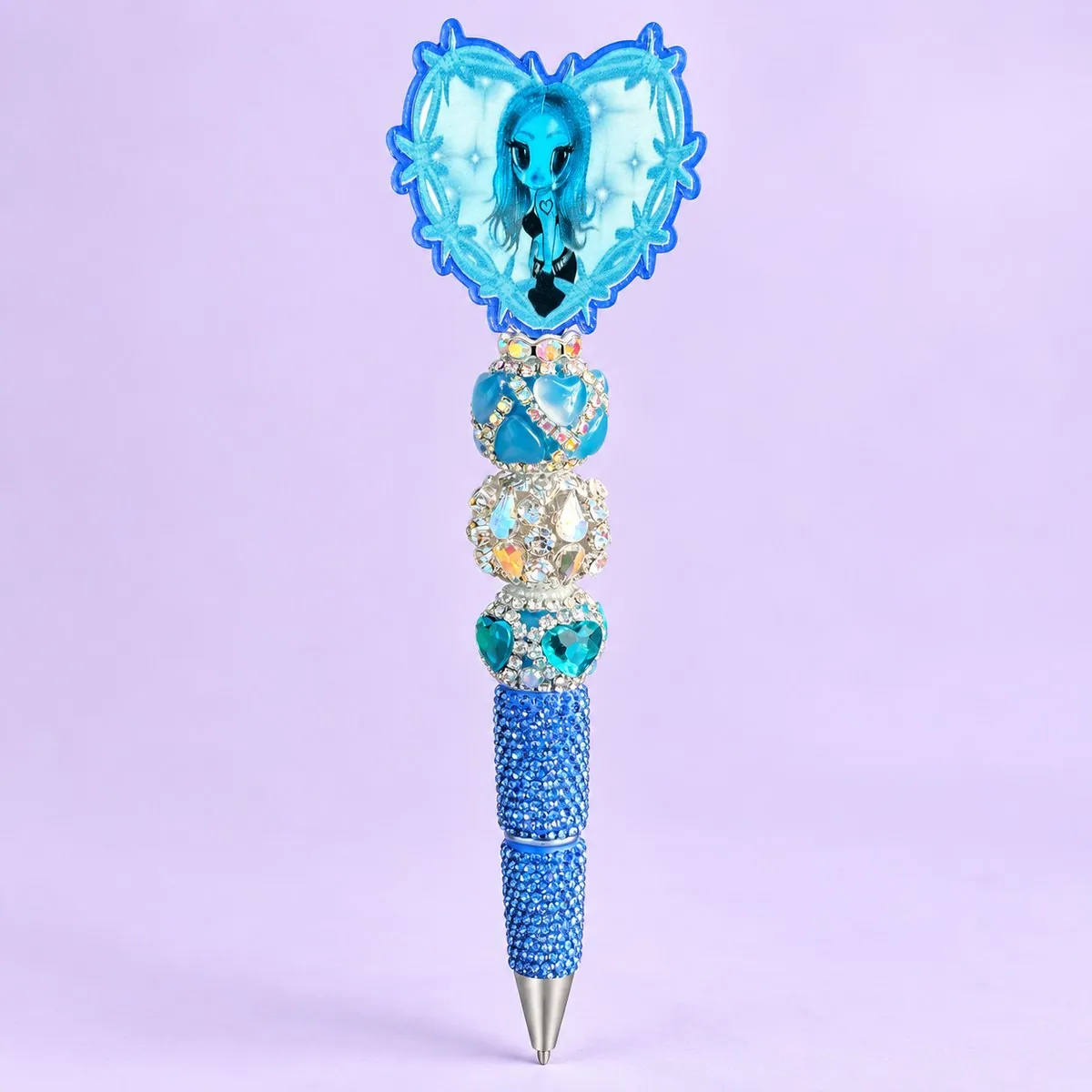 Blue Heart Girl Bling Pen on a pale lavender backdrop — beaded pen with a blue heart-shaped topper printed with a blue-toned girl, stacked blue heart, clear rhinestone and teal heart beads, and a blue rhinestone barrel