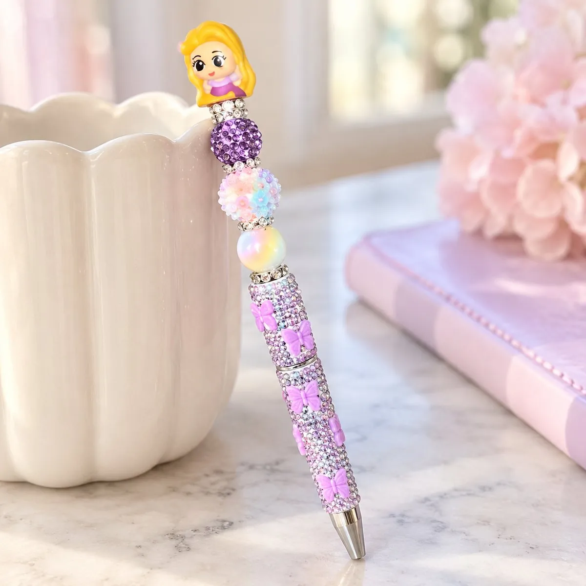 The Tower Princess Beaded Pen styled in a soft pastel setting