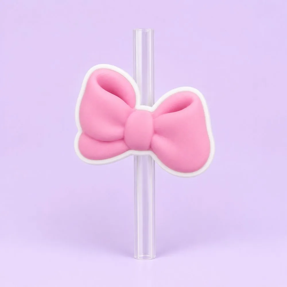 Baby Pink Bow Topper on a clear straw, pale lavender backdrop — shaped like a soft baby-pink puffy bow