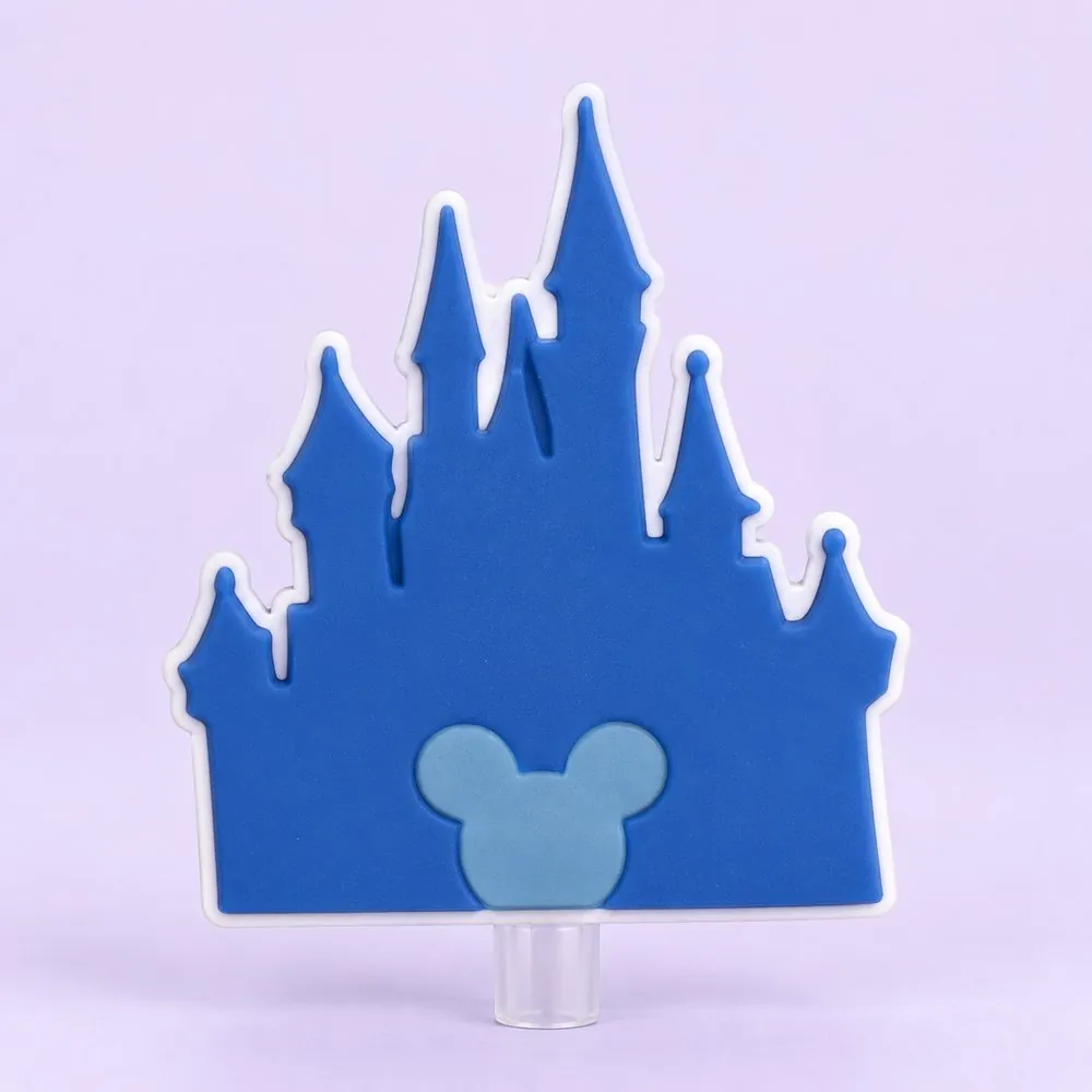 Blue Castle Topper on a clear straw, pale lavender backdrop — shaped like a blue fairytale castle silhouette with a small light-blue mouse-ears emblem on its door