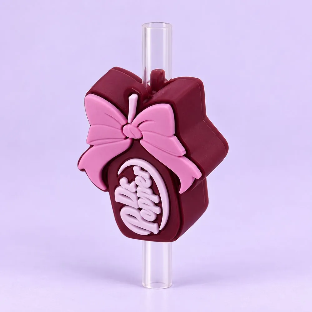 Bow Coffee Cup Topper on a clear straw, pale lavender backdrop — shaped like a maroon coffee cup with a pink bow