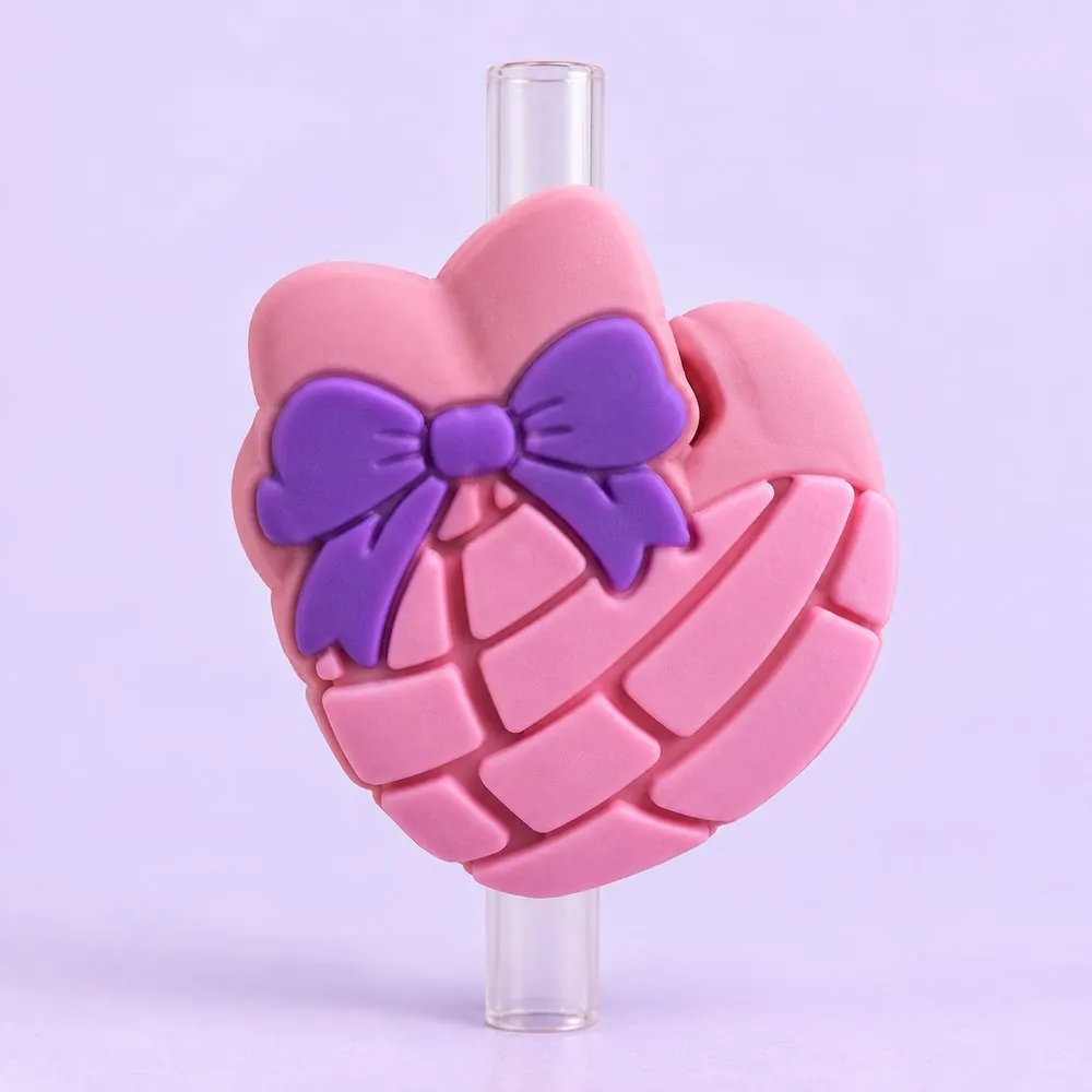 Concha Bow Topper on a clear straw, pale lavender backdrop — shaped like a pink concha sweet bread with a purple bow