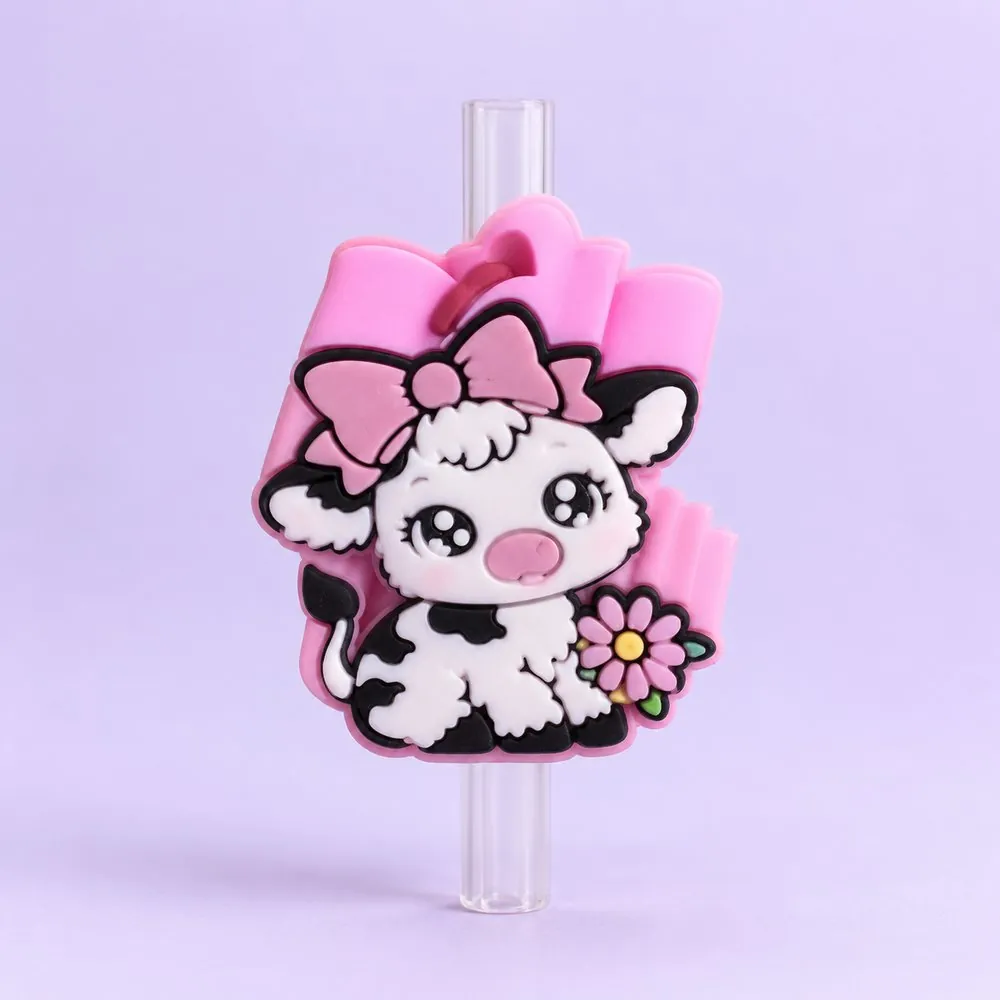 Cow Print Lamb Topper on a clear straw, pale lavender backdrop — shaped like a cow-print lamb with a pink bow and flower