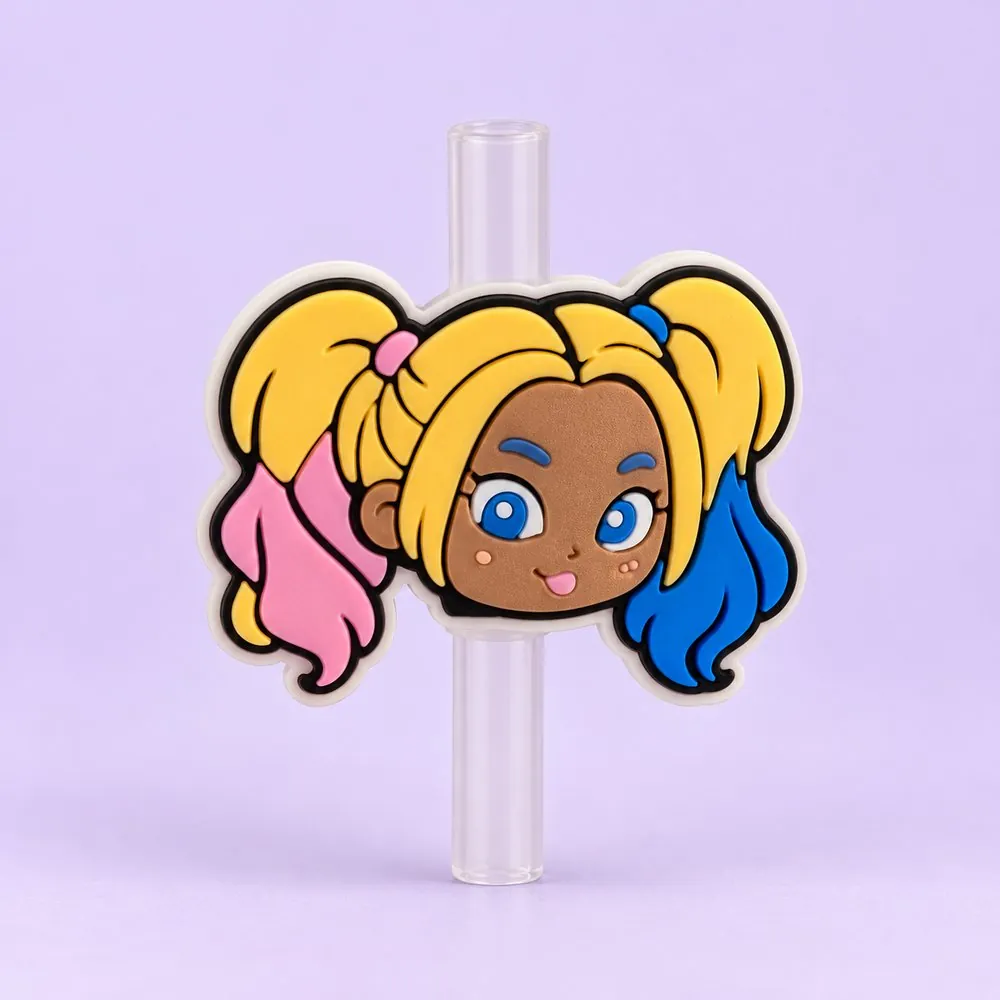 Pigtail Girl Topper on a clear straw, pale lavender backdrop — shaped like a cartoon girl with blonde pigtails tipped pink and blue
