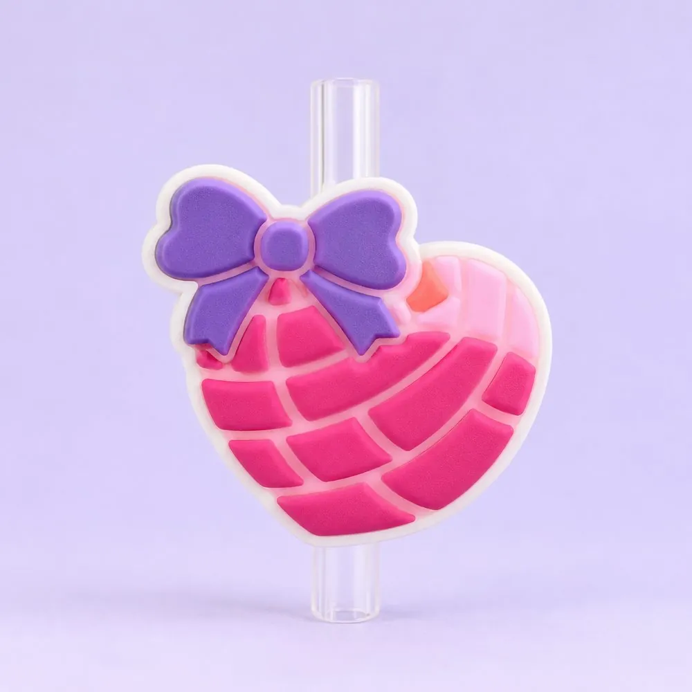 Pink Concha Heart Topper on a clear straw, pale lavender backdrop — shaped like a pink heart-shaped concha sweet bread with a purple bow