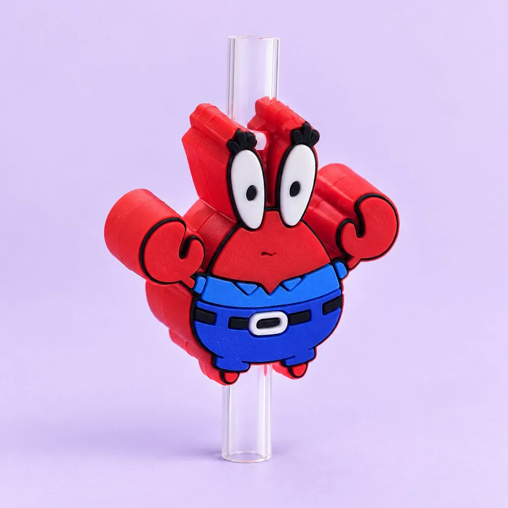 Red Crab Topper on a clear straw, pale lavender backdrop — shaped like a red cartoon crab in a blue shirt and belt