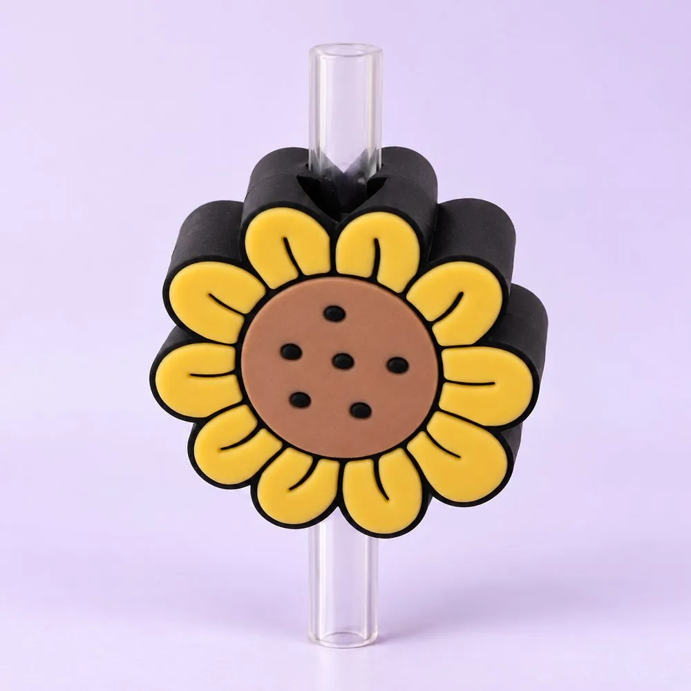 Sunflower Topper on a clear straw, pale lavender backdrop — shaped like a yellow sunflower with a brown center
