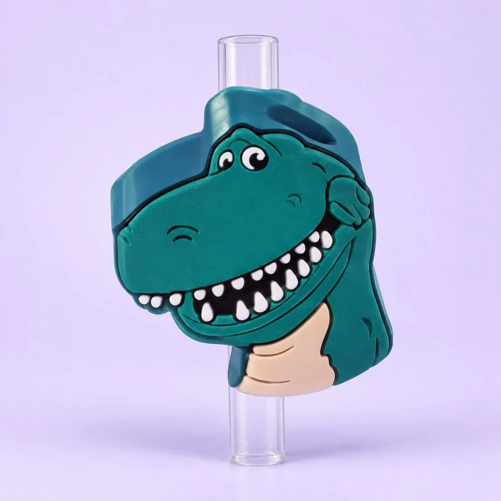 Toy Dino Topper on a clear straw, pale lavender backdrop — shaped like a teal cartoon toy tyrannosaurus head with a big toothy grin